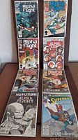 Eight Marvel comic books arranged in two columns, featuring Alpha Flight and Superboy covers visible, with colorful and dramatic superhero artwork.