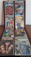 Eight comic books arranged in two rows, all first issues with protective plastic covers, showing covers with various illustrated characters and titles