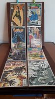 Eight comic books arranged in two rows showing front covers, includes Batman, Animal Man, Justice League, Flash, Batman Black & White