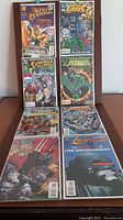 Set of 8 DC Comics comic book first issues arranged on chair showing front covers.