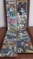 Eight Marvel Punisher War Journal comics laid out in two rows on a brown surface, showing front covers with various action scenes and characters.