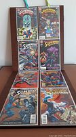 Photo showing all 8 comic books arranged in two rows; titles and cover art visible