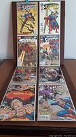 Eight DC Superman Extreme Age comic books laid out in two groups showing full front covers, all in very good condition or better.