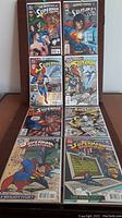 Eight DC Superman comic books arranged in two rows of four, showing front covers with vibrant artwork.