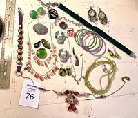 Overview of lot showcasing diverse assortment of costume jewelry including bracelets, necklaces, earrings, and rings arranged for clear identification.