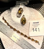 Full set showing amber ring, bracelet, and pendant on fabric with ruler for size reference
