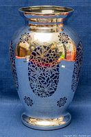 Front view showing cobalt blue vase with intricate silver floral cut-out overlay and reflective finish