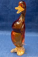 Front view of standing Murano amber glass duck figurine showing detailed head, body, and feet.