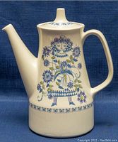 Side view of Figgjo Lotte Turi design coffee pot showing spout, handle and floral figure decoration.