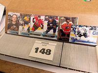 Photo showing a selection of 2016-2017 Upper Deck Series One hockey cards in sleeves, featuring players from different teams.
