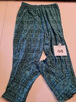 Blue-green patterned Sweetlegs Plus leggings size 16-18 laid flat showing elastic waistband and leg length