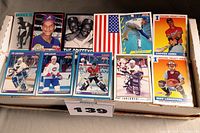 Close-up of various hockey and baseball cards showing players like Chipper Jones, Mike Lieberthal, Nolan Ryan and several hockey player cards.