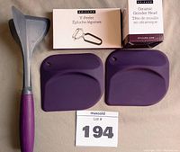 Ground meat separator, fruit bowl scrapers, Y-peeler, and ceramic grinder head arranged together with lot tag