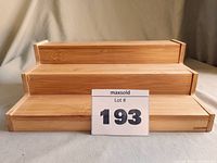 Front view of the closed 3-tier bamboo rack showing three stepped display levels in natural bamboo color.