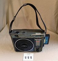 Front view of the General Electric portable 8-track player and AM-FM radio showing speaker, control panel, and 8-track tape inserted.