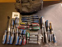 Complete set of screwdrivers and bits laid out showing variety of handles and bits included.