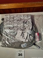 Folded Thirty One stand tall bin in original packaging, showing fabric texture and logo.