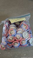 Zip-lock bag of pinback buttons with handwritten “250” note