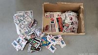 Overview of loose sports cards, sealed packs, keychains, bumper stickers, and temporary tattoos inside and around a box