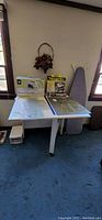 View of foldable crafting table set up with some extra items on top not included.