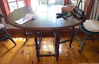 Full view of the table with leaves extended and turned spindle legs visible