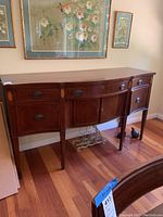Front view of the 1930s mahogany buffet cabinet with drawers and cabinet doors closed, showing the polished wood surface and classic style handles.