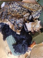 Casket cover draped over sofa, showing full floral pattern and black fringe