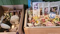 Full view of box contents showing fairy figurines, books and a decorative plate