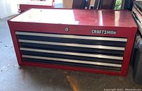 Front view of the red Craftsman 4-drawer metal toolbox showing brand logo and drawers.