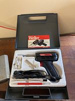 Weller universal soldering gun Model 8200 with multiple tips, wrench, brush, power cord in molded case inside plastic carrying case with manual