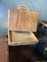 Closed wooden case with handle, part of the lot but not the main tool cases.