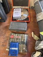 Overview photo showing all items together on a wooden bench, including the dado set, flexible socket set, hollow shank nut drivers, and punch tool set.