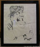 Full frontal photo of the framed signed print of a drawing of Mick Jagger showing the entire artwork and frame.
