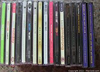 Spine view showing 16 assorted jazz CDs with clear jewel cases and various artist labels.