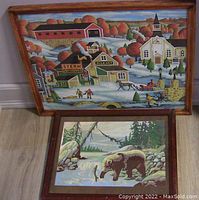 Folk art village scene with buildings, horse and sleigh, church, people, and fall foliage in natural wood frame
