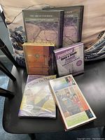 Photo showing six audio media items including CDs and one tape cassette. Topics include French learning, Tai-Chi, Pilates, and literature.