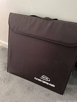 Black carry case labeled DIGITAL Portable Lighting Studio for the portable lighting kit