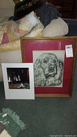 Framed sketch of cocker spaniel with wood frame, red matte. Framed piece with scratches on frame/glass. Lot includes separate unframed print with matting leaning next to it.