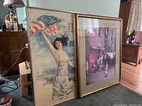 Two framed historical posters lean against a wall and dresser; left is the WW1 war bond poster, right is the Norman Rockwell print.