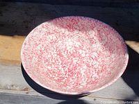 Top view of large red and white spatterware bowl showing interior pattern and shape.