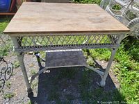 Front view of vintage oak wood top and wicker desk showing diamond pattern wicker sides and one support shelf below.