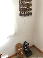 Three wooden spoon display holders, two freestanding and one wall-mounted, each holding multiple collectible spoons.