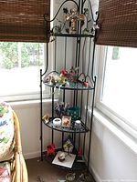 First collapsible corner rack filled with decorative items near window