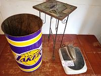 Photo showing all three items: LA Lakers wastebasket, dolphins mosaic side table, and Detecto bath scale