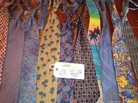 Front view of 10 men's ties showing various colorful patterns and fabrics