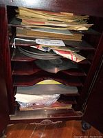 Wooden shelf unit filled with vintage 78 RPM records in paper sleeves