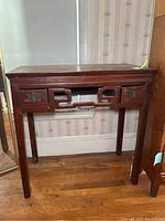 Front view of the desk showing two drawers and decorative apron