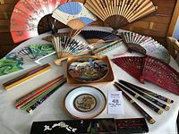 Full assortment showing decorative fans, plates, chopsticks and boxes.