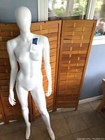 Front view of full mannequin showing white finish and feminine form in a standing pose.