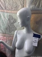 Front and side view of white female mannequin torso showing sculpted features.